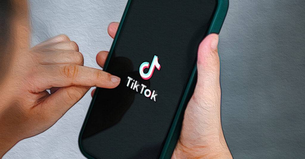 holding smartphone with tiktok application icon